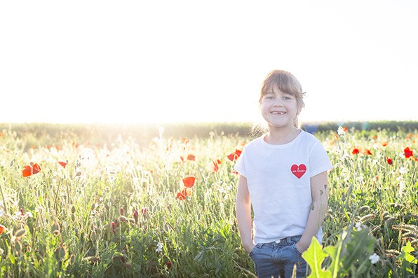 Photographe famille dijon fille pose dans un champ de coquelicot